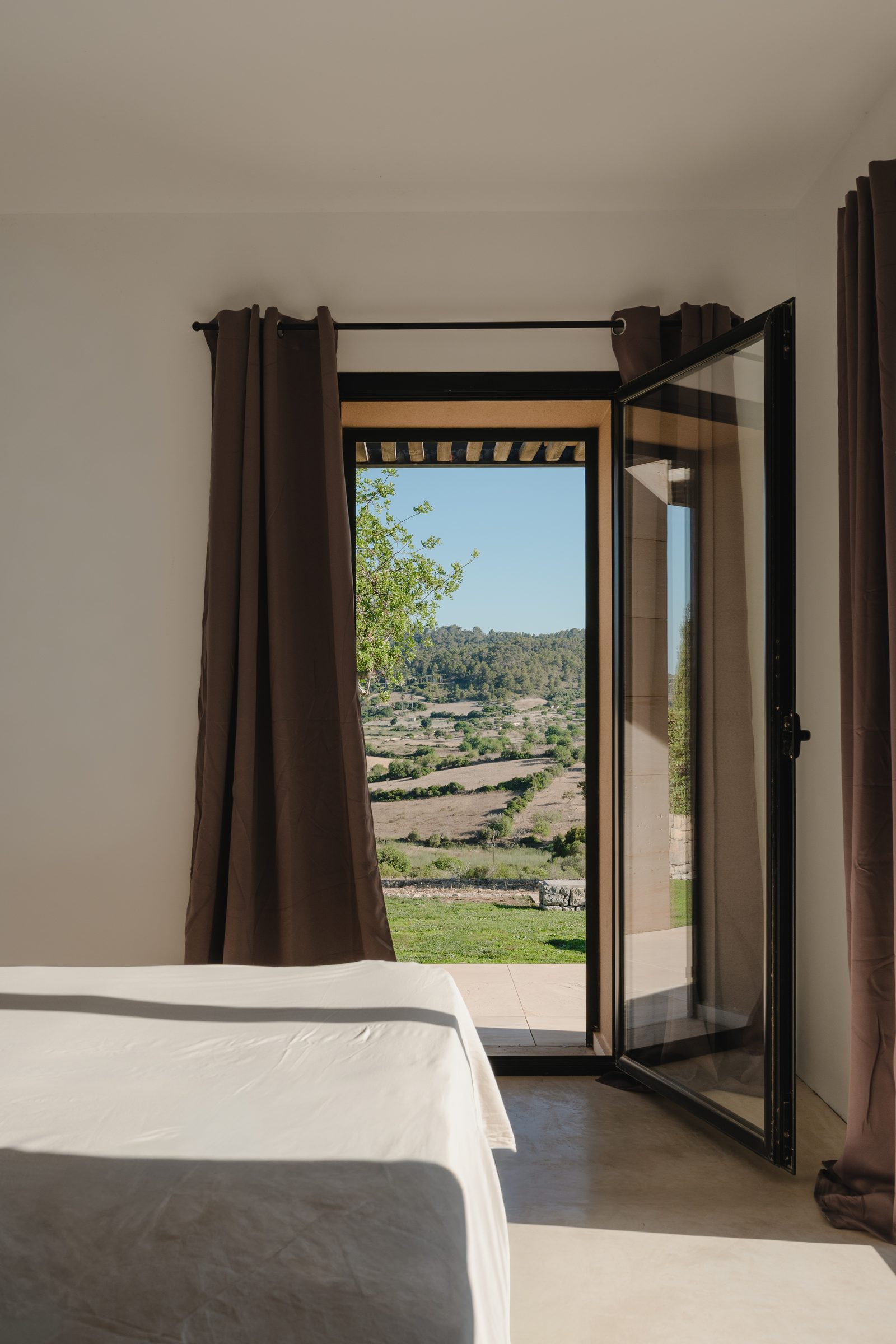 Schlafzimmer mit direktem Zugang ins Freie und Blick in die Landschaft